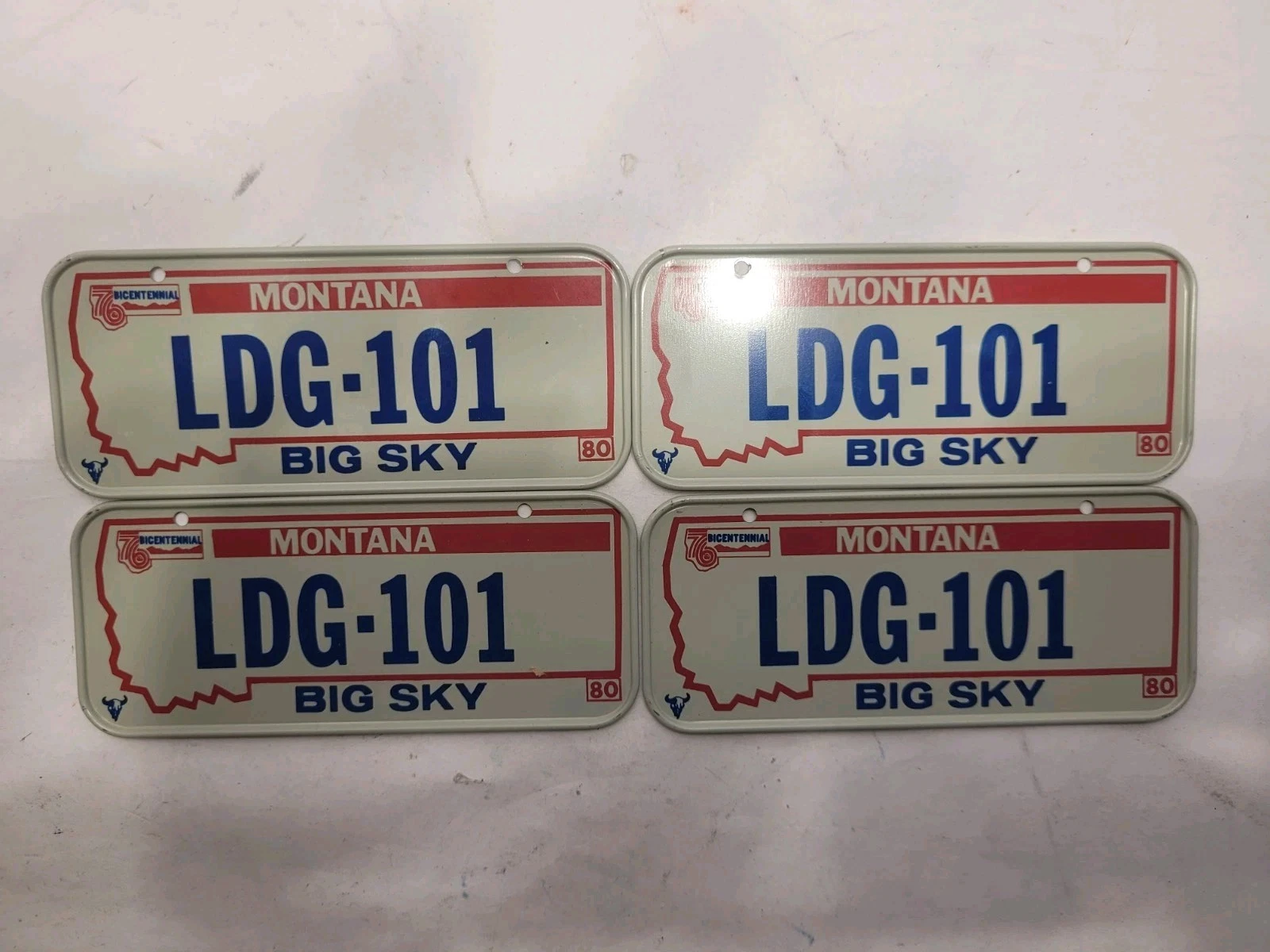 Four 1980 Montana Big Sky miniature bicycle license plates from a new-old-stock lot