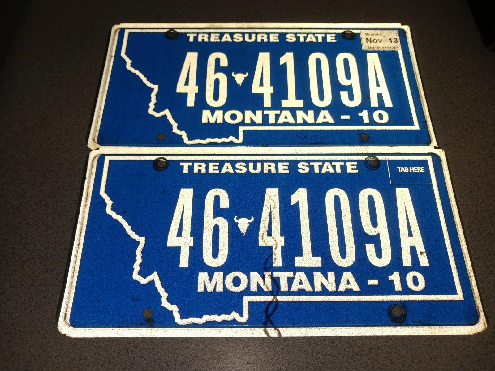 Used vintage blue Montana Treasure State license plates with assorted letters and numbers